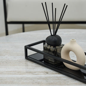 Detail shot of Black modern large rectangle tinted mirrored decorative tray on Artemis travertine table