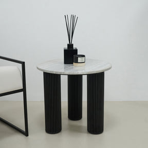 Travertine round side table adorned with incense and candle