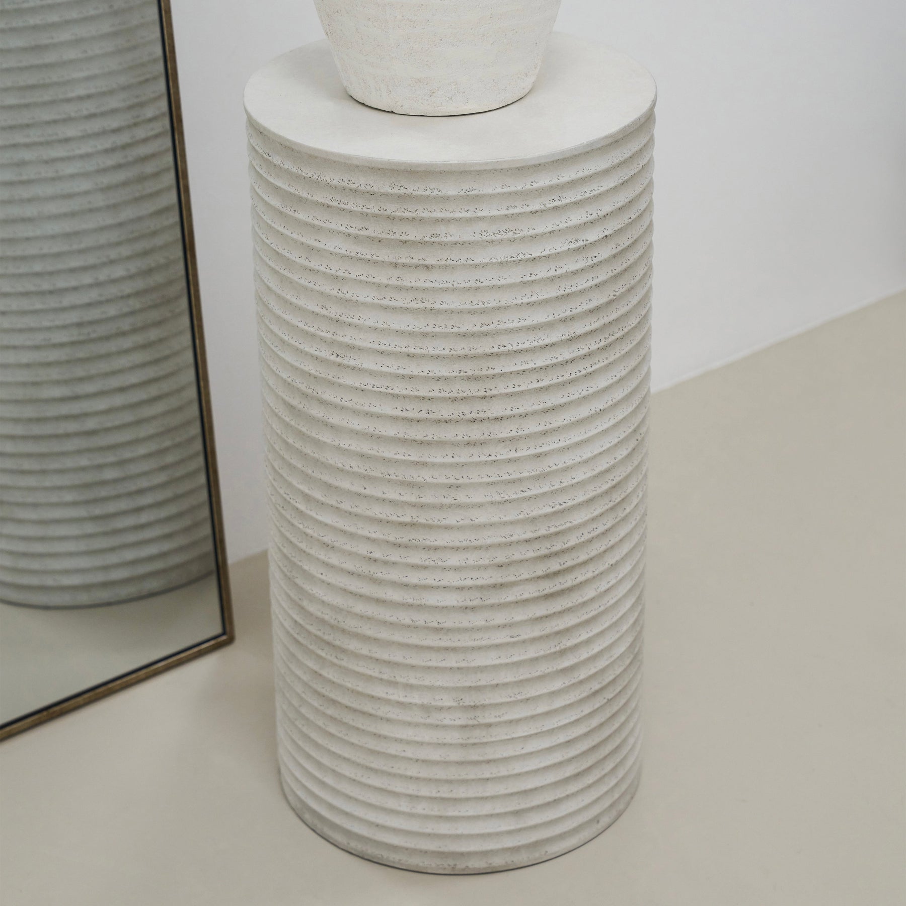 alternate angle of Minimal Concrete Ribbed Plinth beside mirror