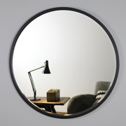 Black Metal Modern Round Wall Mirror reflecting lounge