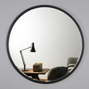 Black Metal Modern Round Wall Mirror reflecting lounge