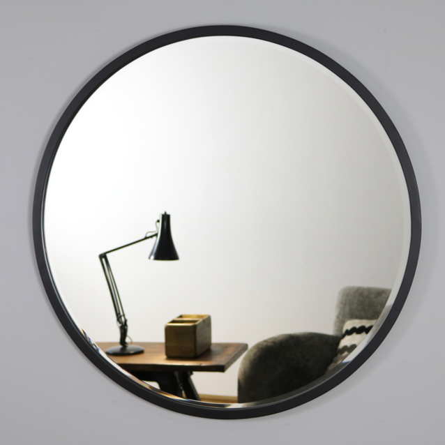 Black Metal Modern Round Wall Mirror reflecting lounge