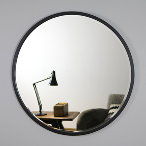 Black Metal Modern Round Wall Mirror on living room wall