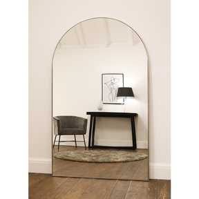 Champagne Full Length Arched Metal Mirror reflecting lounge