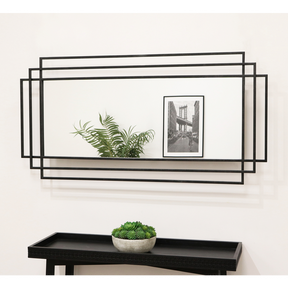 Large black rectangular metal mirror displayed on wall