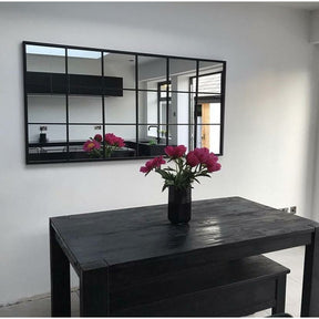 Full length large black metal window mirror displayed horizontally on wall