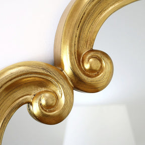 A detail of this mirrors ornate frame moulding.